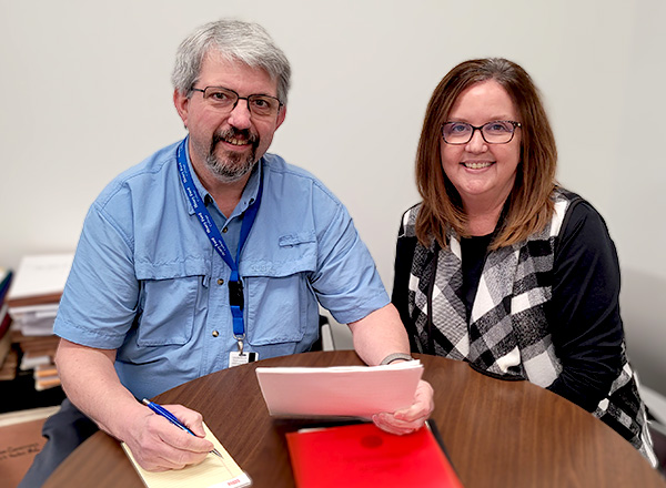 Kevin Culler and Stephanie Latzke meeting at a desk.