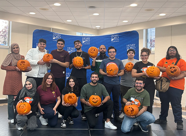 International students with their carved pumpkins.