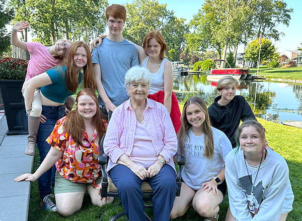 Judy Koos surrounded by eight of her nine grandchildren. 