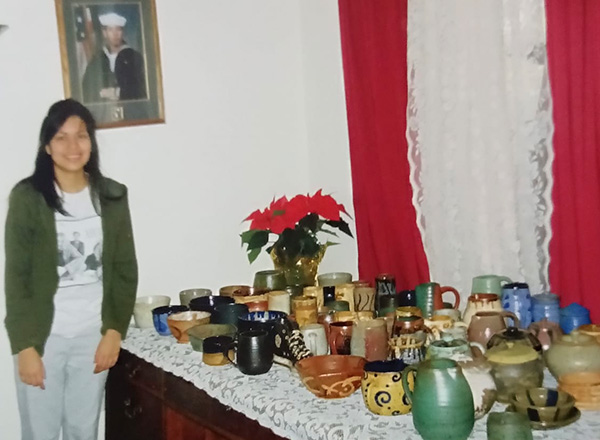 Adriana Sanchez poses with her pottery back when she was a student at HFC. 