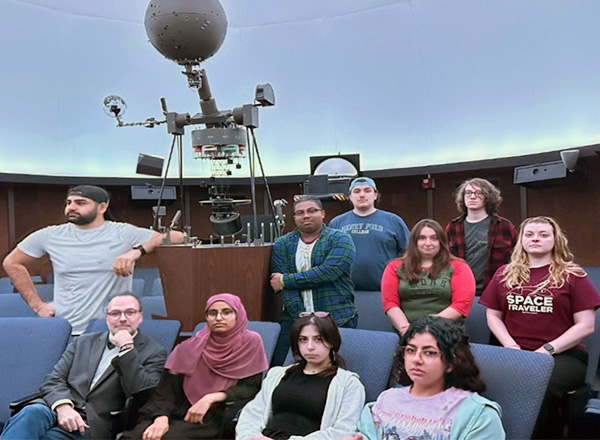 Group photo of the Dead Stars Society inside the Hammond Planetarium. 