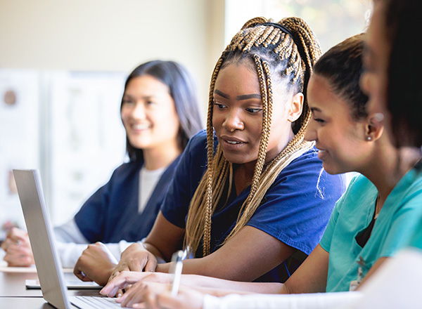 Nursing students studying together in a classroom.