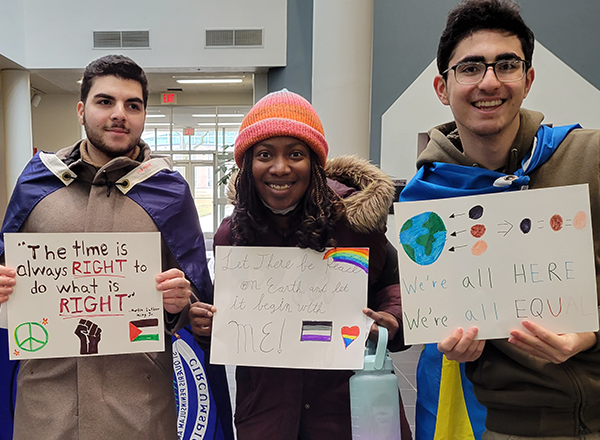 HFC students holding up the protest posters they made.